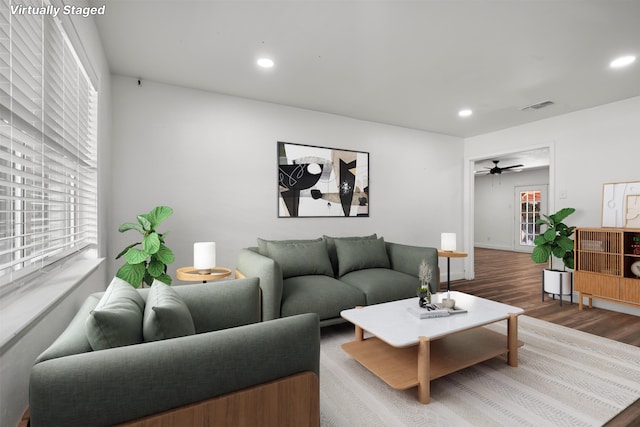 living room featuring a ceiling fan, wood finished floors, visible vents, baseboards, and recessed lighting