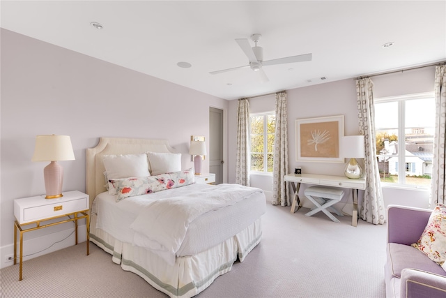 bedroom with light carpet, visible vents, and a ceiling fan