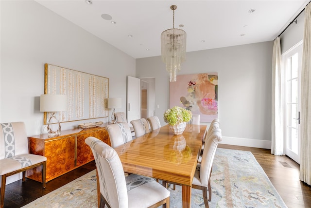 dining room featuring recessed lighting, baseboards, an inviting chandelier, and wood finished floors