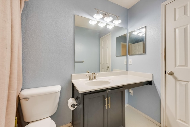 bathroom featuring toilet and vanity