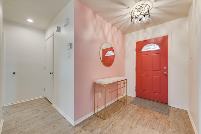 entryway with recessed lighting, baseboards, a chandelier, and light wood finished floors