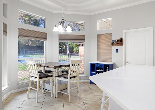 dining space with baseboards, ornamental molding, light tile patterned floors, a high ceiling, and a notable chandelier