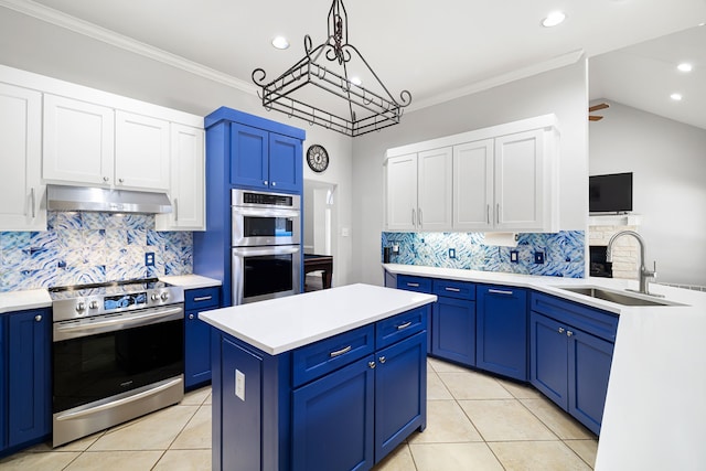 kitchen with blue cabinetry, stainless steel appliances, under cabinet range hood, and a sink