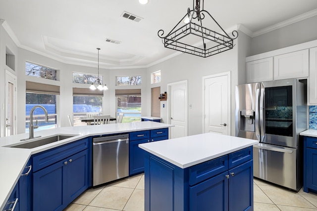 kitchen featuring a notable chandelier, blue cabinetry, stainless steel appliances, and a sink