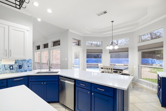 kitchen with blue cabinets, visible vents, a sink, light countertops, and dishwasher