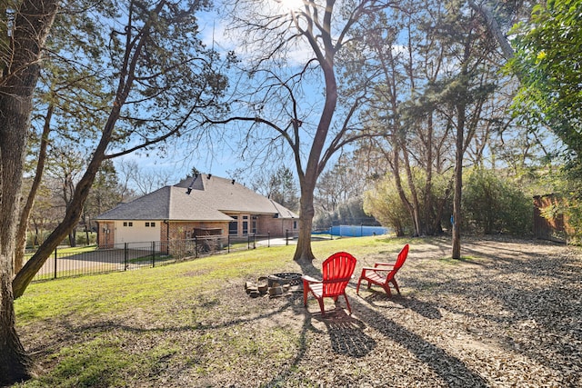 view of yard featuring a fenced backyard and an outdoor fire pit