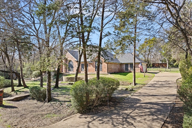 view of community with a yard and driveway