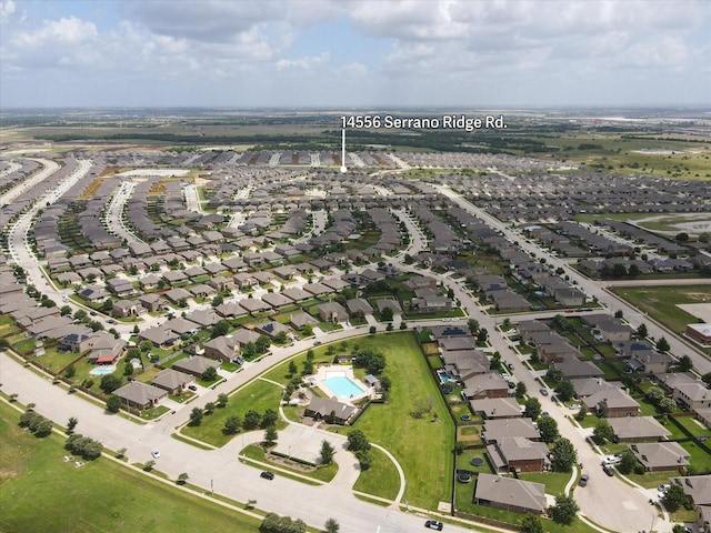 birds eye view of property with a residential view