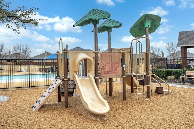 community playground with a community pool and fence