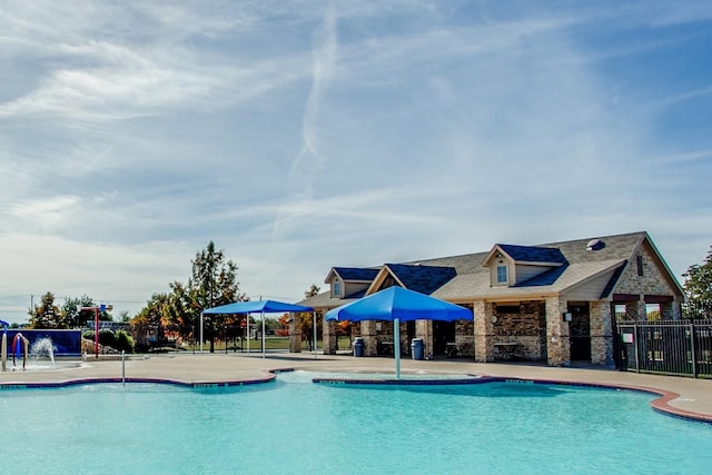 community pool featuring a patio area and fence