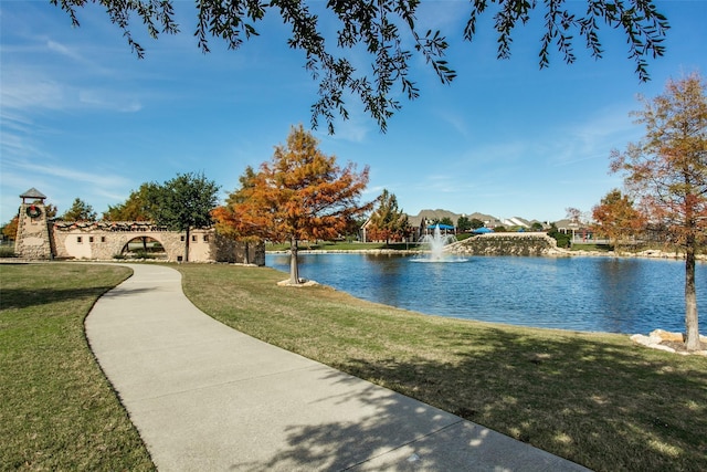 view of community with a yard and a water view