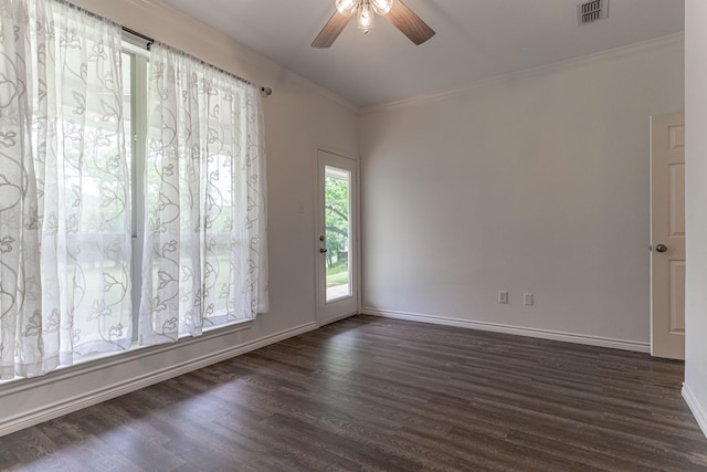 unfurnished room with a ceiling fan, baseboards, dark wood-style floors, visible vents, and ornamental molding