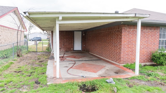 view of patio / terrace featuring a carport and fence