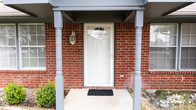 view of exterior entry with brick siding