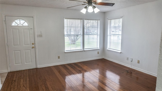 foyer entrance featuring a ceiling fan, wood finished floors, baseboards, and a textured ceiling