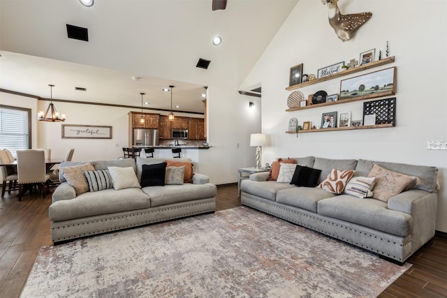 living room featuring crown molding, dark wood-type flooring, a chandelier, recessed lighting, and high vaulted ceiling