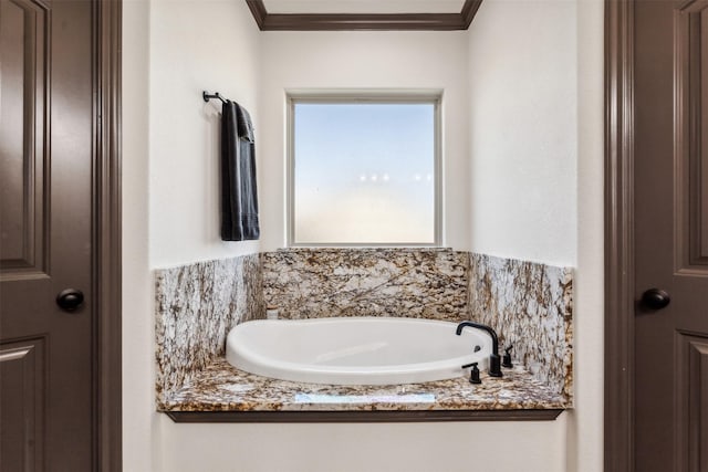 full bathroom with crown molding and a garden tub