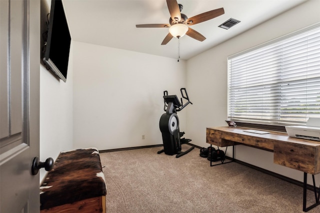 exercise room with visible vents, carpet flooring, baseboards, and ceiling fan