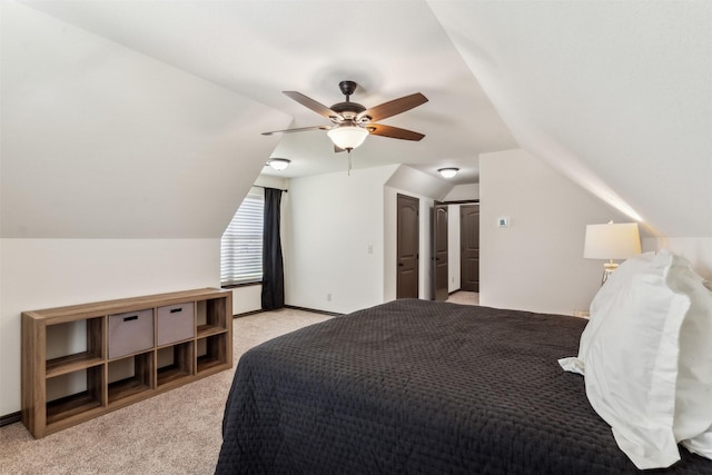 bedroom with a ceiling fan, vaulted ceiling, light colored carpet, and baseboards