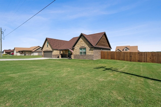 french provincial home featuring a front lawn, fence, and brick siding