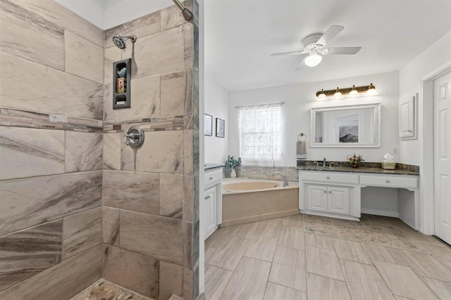 full bathroom with a tile shower, a bath, vanity, and ceiling fan