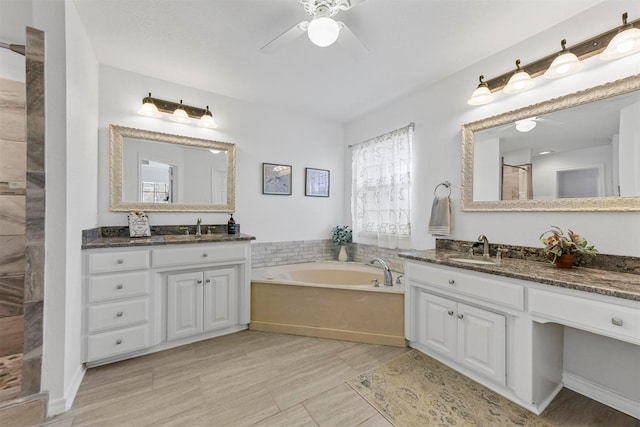 full bathroom with a shower, two vanities, a bath, and a sink