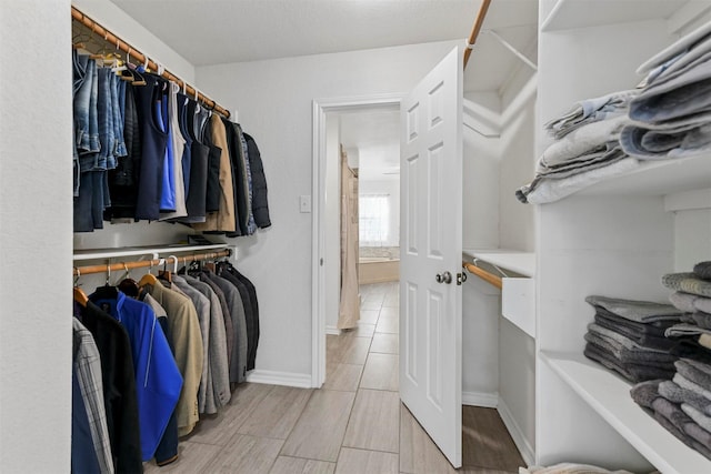 walk in closet featuring wood tiled floor