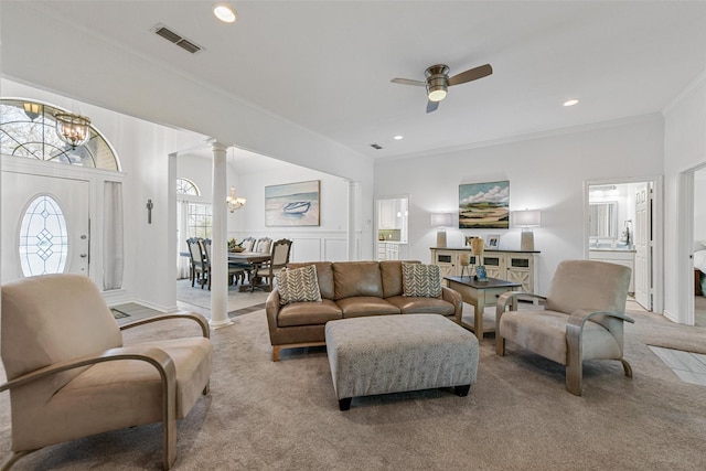 living area featuring visible vents, ornamental molding, recessed lighting, carpet floors, and ornate columns