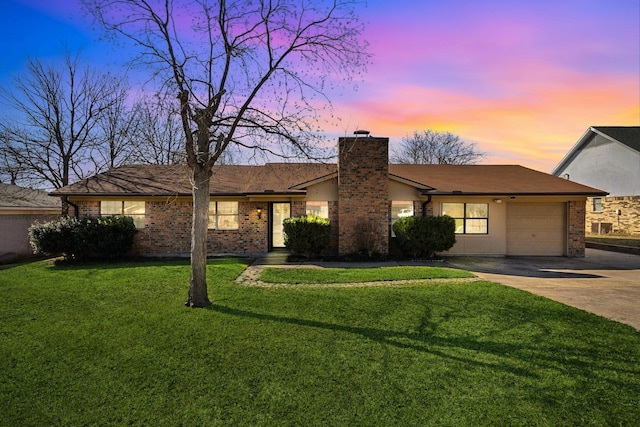 single story home featuring concrete driveway, an attached garage, brick siding, and a chimney