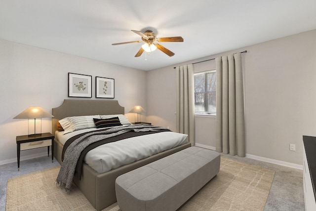 bedroom featuring baseboards, light carpet, and a ceiling fan