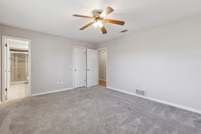 unfurnished bedroom with visible vents, carpet flooring, and baseboards