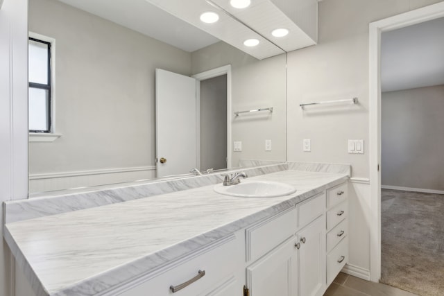 bathroom featuring recessed lighting, vanity, and baseboards