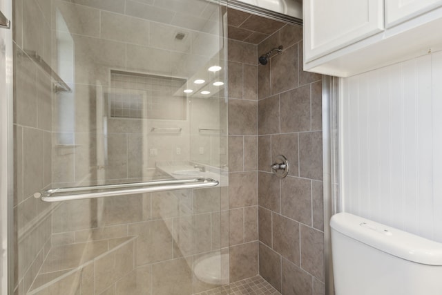 bathroom with toilet and a shower stall