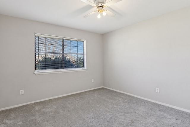 spare room featuring baseboards, carpet floors, and ceiling fan