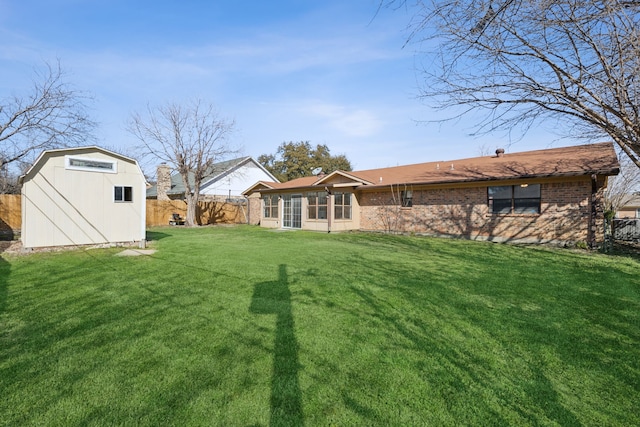 view of yard with an outdoor structure, a storage unit, and fence