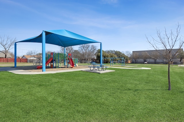 community play area with a yard and fence