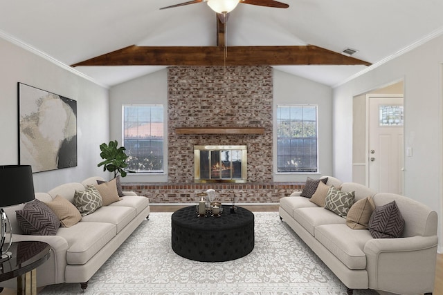 living area with plenty of natural light, a fireplace, lofted ceiling, and ornamental molding