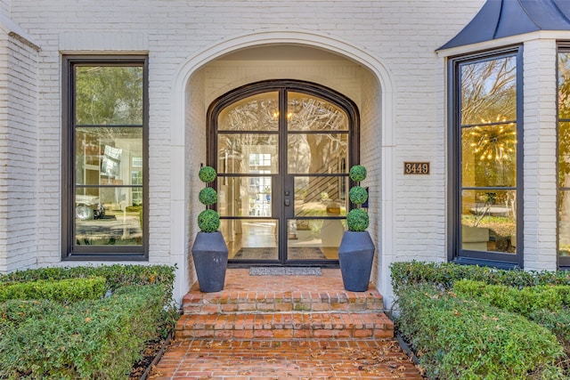 view of exterior entry with brick siding