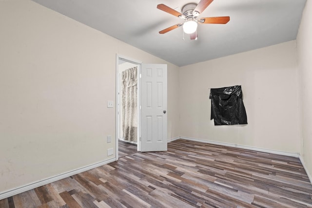 empty room featuring a ceiling fan, wood finished floors, and baseboards