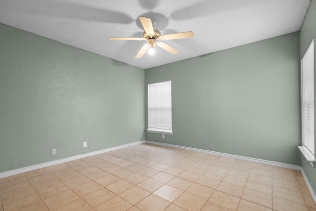 unfurnished room featuring light tile patterned floors, baseboards, and ceiling fan