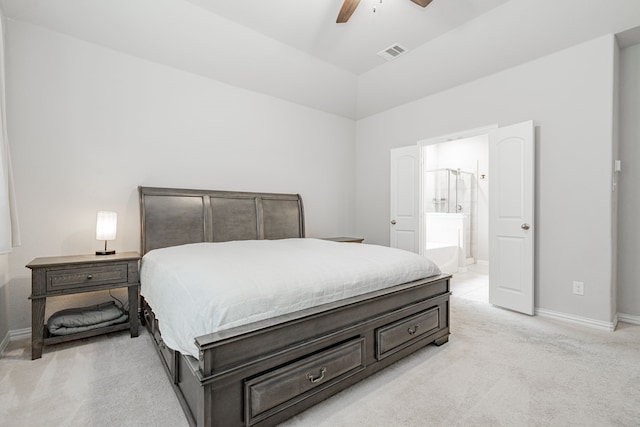 bedroom with visible vents, baseboards, light colored carpet, and connected bathroom