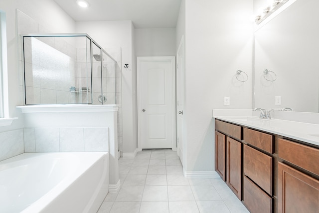 bathroom with a garden tub, a stall shower, a sink, tile patterned flooring, and double vanity