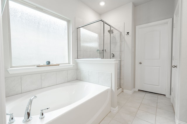 bathroom with a bath, tile patterned floors, and a stall shower