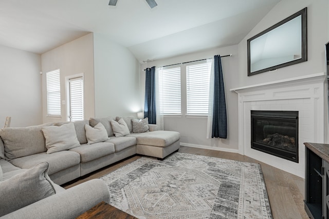 2304 Ravensway Rd, Crandall, TX 75114 - living room featuring wood finished floors, ceiling fan, vaulted ceiling, and a brick fireplace
