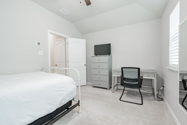 bedroom with light carpet, visible vents, multiple windows, and lofted ceiling