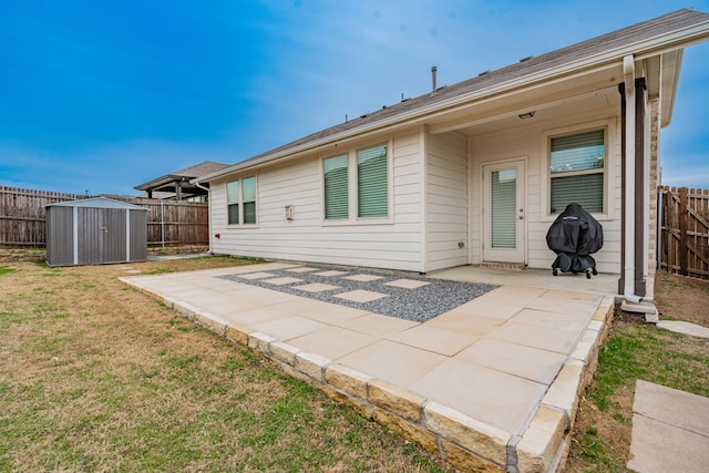 back of property with a patio area, a fenced backyard, a storage shed, and an outdoor structure