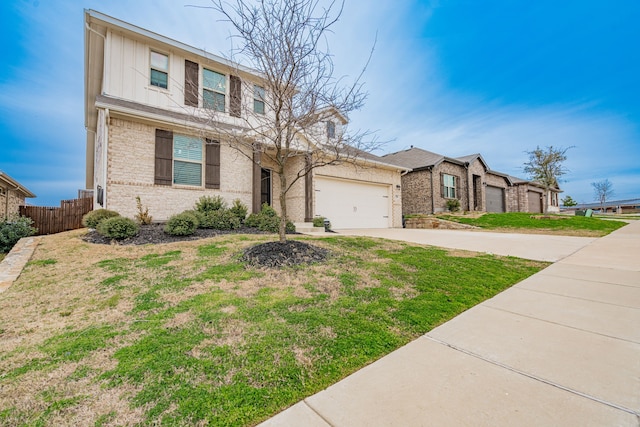 2304 Ravensway Rd, Crandall, TX 75114 - view of front of house with concrete driveway, a garage, brick siding, and board and batten siding