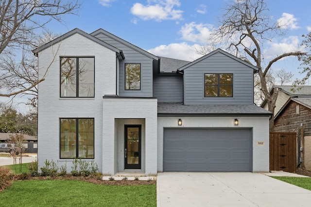 view of front of house featuring brick siding, concrete driveway, an attached garage, and a shingled roof