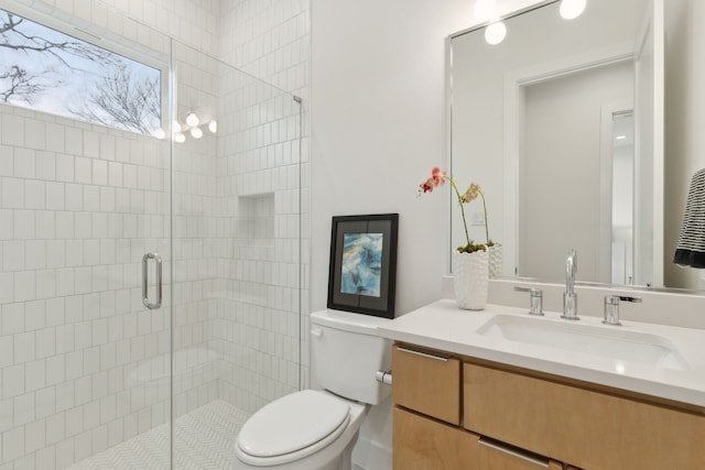 bathroom with vanity, toilet, and a stall shower