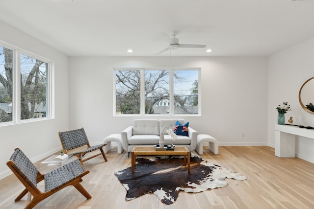 living area with recessed lighting, plenty of natural light, and light wood-style flooring